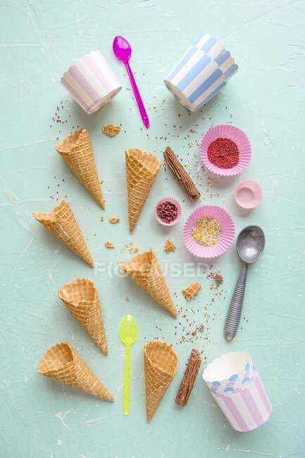 Ice cream cones, containers and sprinkles for ice cream — Stock Photo