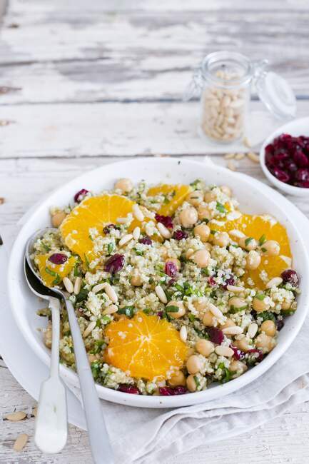 Quinoa salad with orange, chickpeas, cranberries and pine nuts — Stock Photo