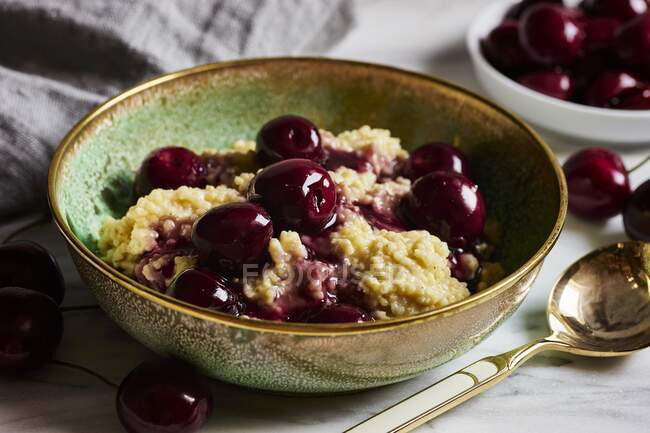 Sweet millet with cherry compote (vegan) — Stock Photo