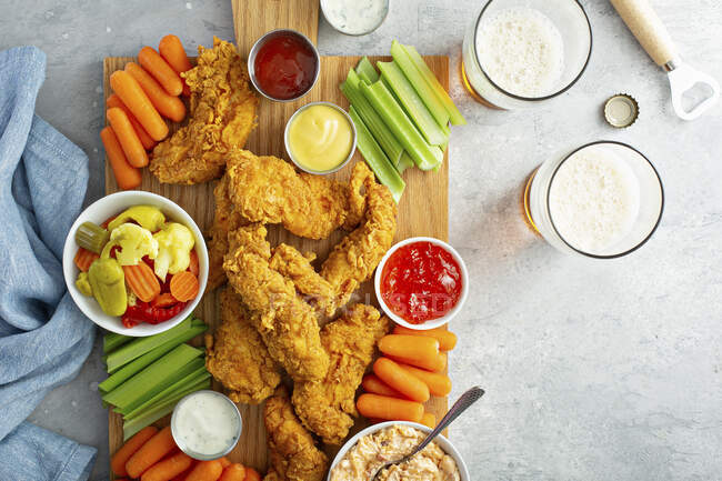 Southern fried chicken platter with all sauces celery and carrots — Stock Photo