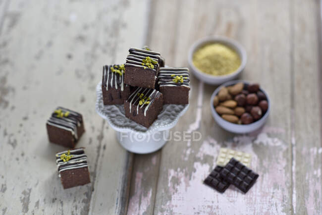 Vegan chai, chocolate and millet bites decorated with chocolate and pistachio nuts — Stock Photo