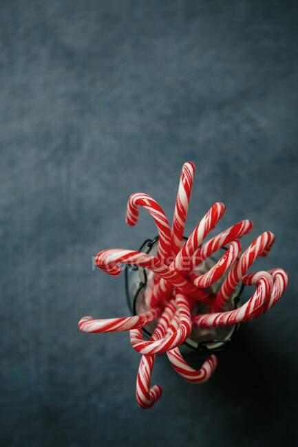 Several candy canes in a container — Stock Photo