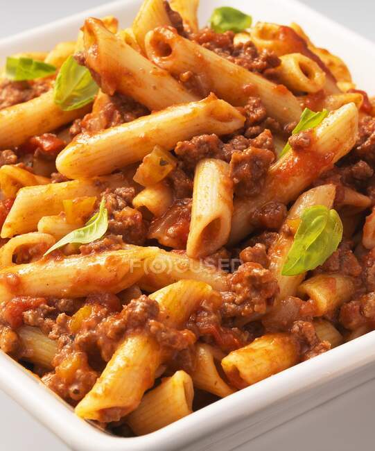 Penne Bolognese pasta with sauce and basil — Stock Photo
