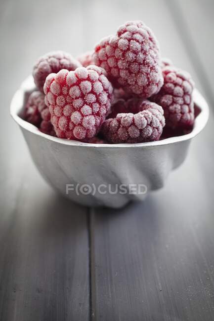 Vintage aluminium mould filled with frozen raspberries — Stock Photo