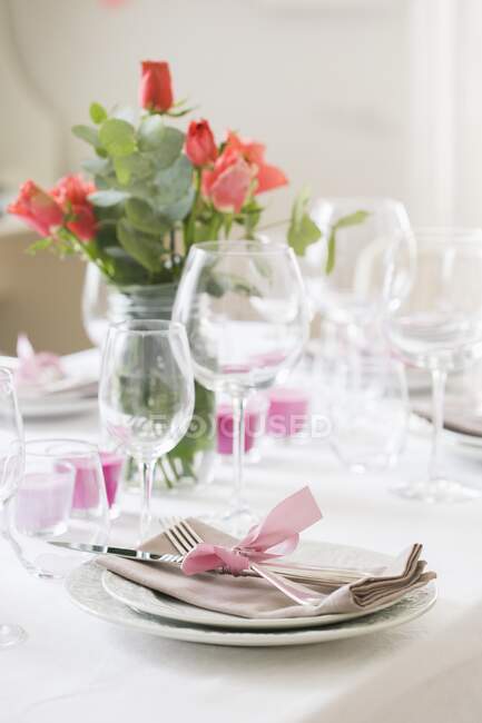 Una tavola apparecchiata con rose e candele — Foto stock