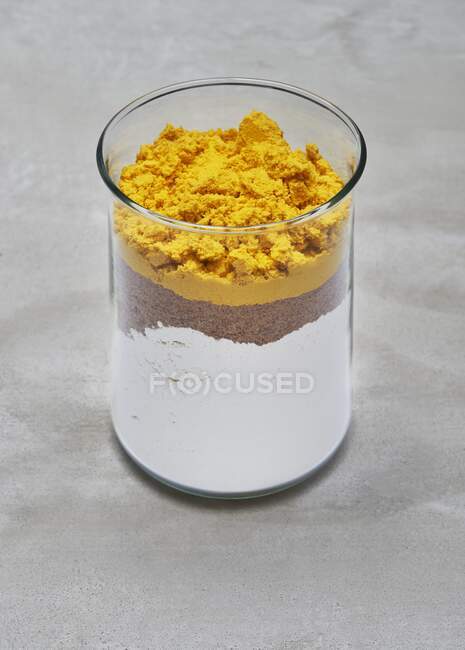 A dry baking mixture for an algae gugelhupf in a glass jar — Stock Photo