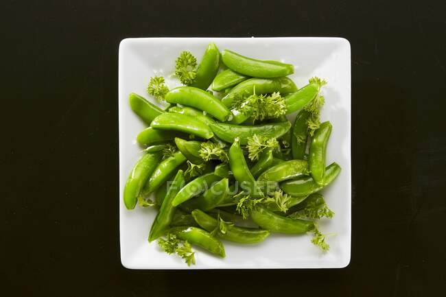 Blanched sugar snacks with parsley and coarse salt — Stock Photo