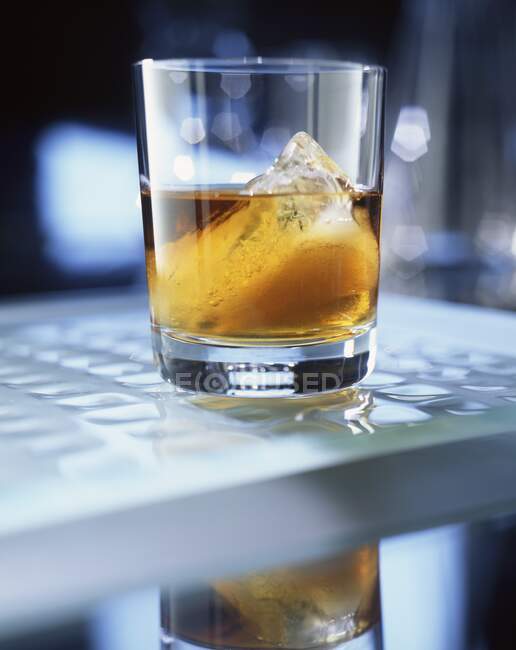 Grand Marnier with ice in glass on table — Stock Photo