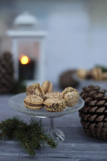 Nougat macaroons with brittle on glass stand for Christmas — Stock Photo
