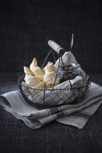 Vegan puff pastries filled with a sugar-free chocolate spread in a wire basket — Stock Photo