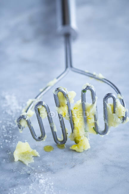 A potato masher with remnants of mash — Stock Photo