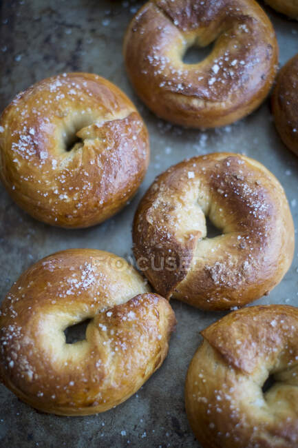 Crisp bagels with sea salt on a baking tray — Stock Photo