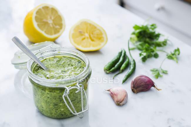 Spicy green chilli sauce with lemon and garlic — Stock Photo