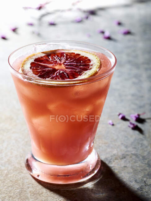 Single Blood Orange cocktail on rustic surface — Stock Photo