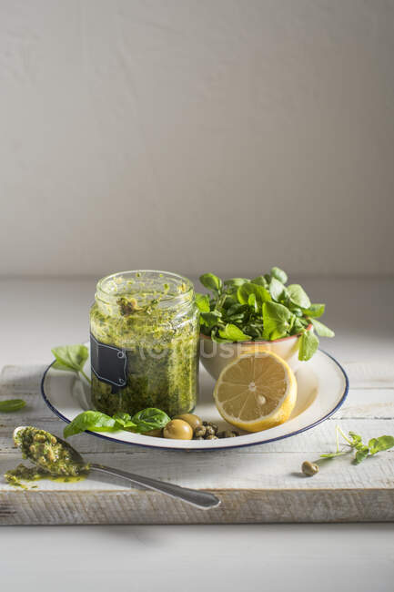 Salsa verde made with watercress, basil olives, capers, lemon, olive oil — Stock Photo