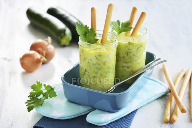 Zucchini soup in glass with grissini — Stock Photo