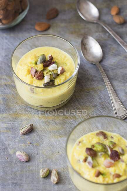 Rice pudding with almonds and pistachios in a glass — Stock Photo