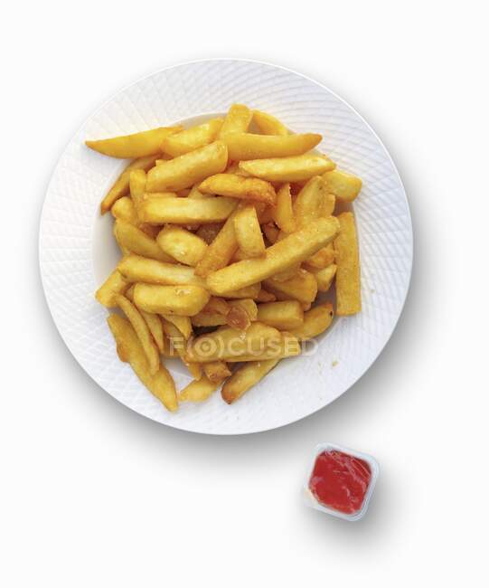 Ketchup on French fries, close-up, elevated view — Stock Photo