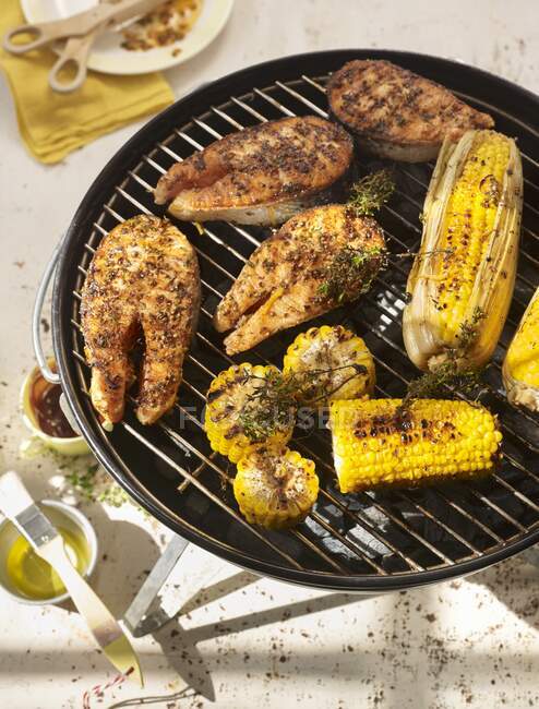 Salmon with corn on the grill — Stock Photo