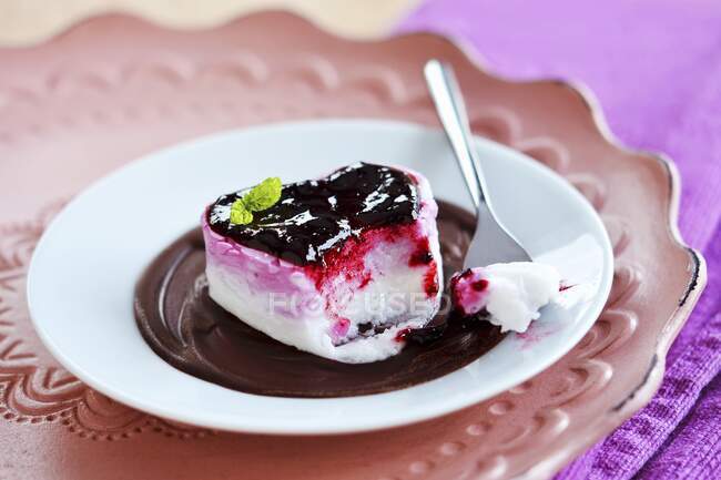 Dessert in heart shape with berry jam on chocolate cream — Stock Photo