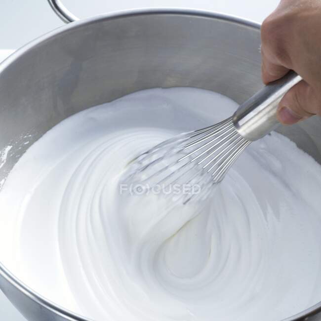 Beating egg whites with a whisk — Stock Photo