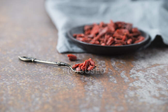 Dried goji berries in a bowl and on a spoon — Stock Photo
