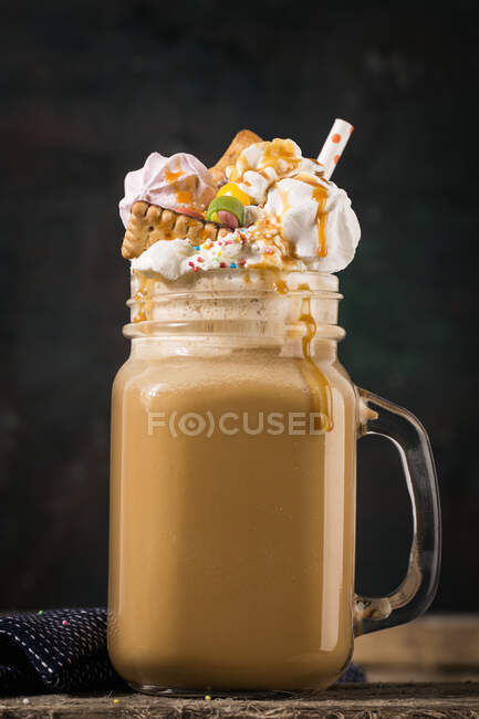 A freak shake with coffee, cream and colorful sweets — Stock Photo
