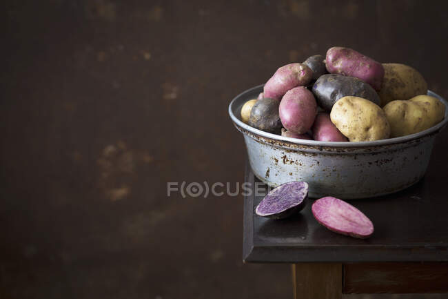 Colorful potatoes in a metal bowl — Stock Photo