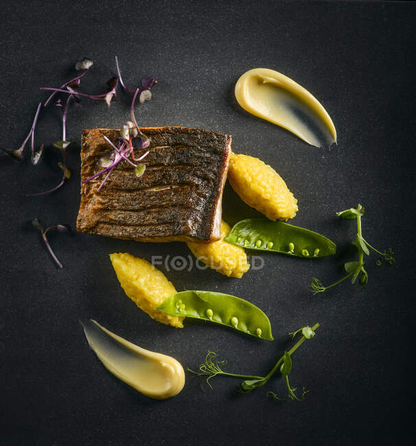 Risotto, fried fish and mangetout — Stock Photo