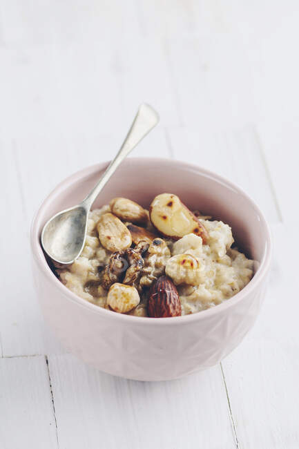 Porridge with roasted hazelunts, almonds, walnuts and brazil nuts — Stock Photo