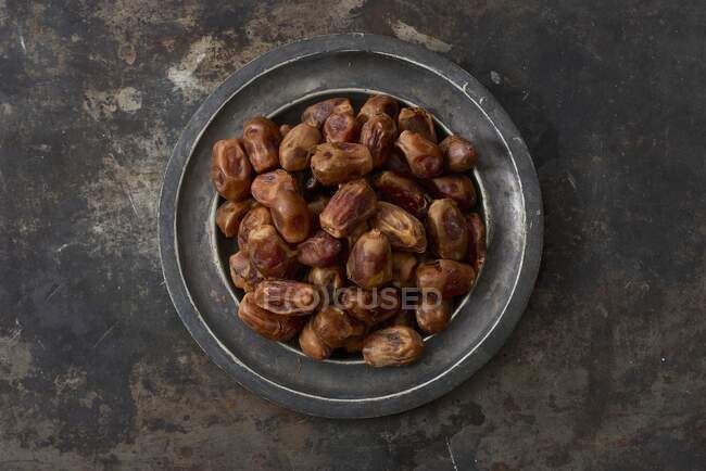 Dried dates on a metal plate — Stock Photo