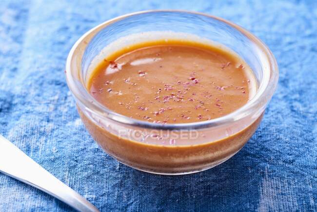 Pepper sauce in glass bowls on a blue background — Stock Photo