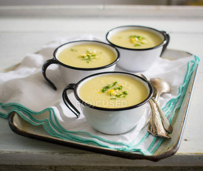 Cream of corn soup in enamel cups — Stock Photo