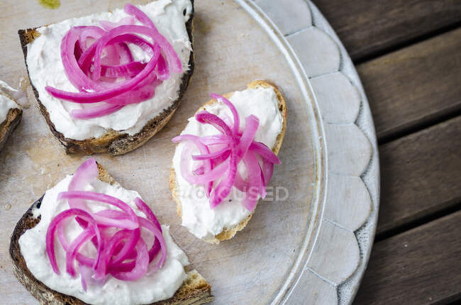 Bruschetta toasted sliced baguette, ciabatta and sourdough bread with mackerel pate and pickled red onion — Stock Photo