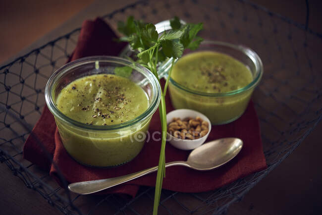 Vegetable soup with zucchini served in glass bowls — Stock Photo