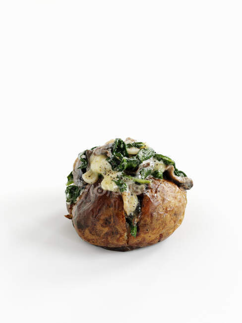 Baked whole potato with spinach, garlic and mushrooms — Stock Photo