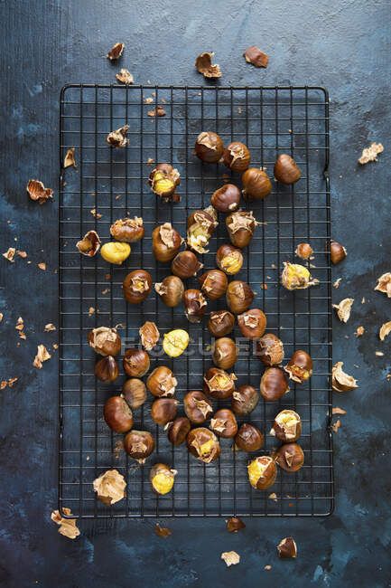 Roasted chestnuts on a cooling rack (seen from above) — Stock Photo