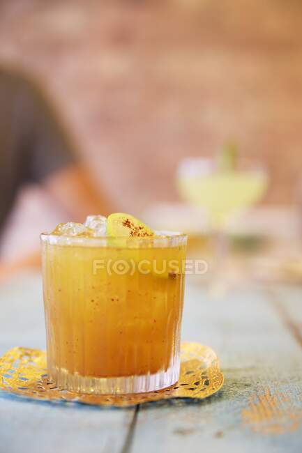 Cocktail with lime and cayenne pepper served on table — Stock Photo