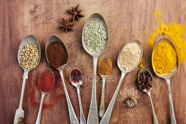 Assorted spices on vintage spoons — Stock Photo