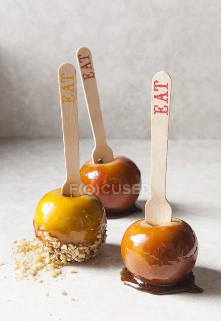 Three toffee apples with almond flakes — Stock Photo