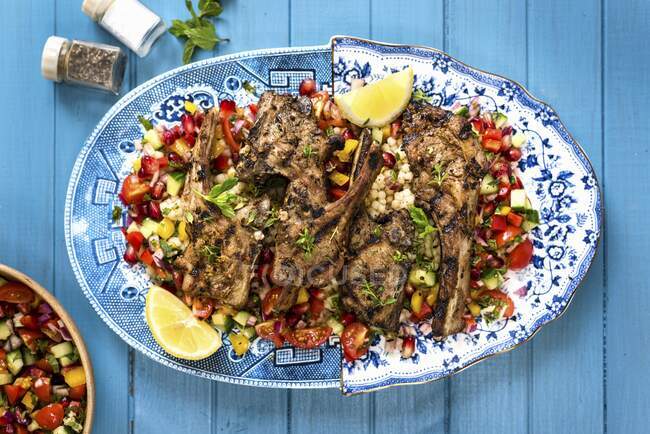 Spicy lamb chops with tomato and pomegranate salsa — Stock Photo