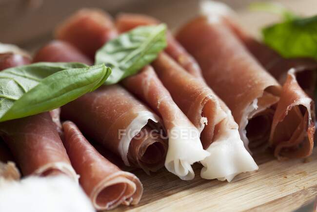 Rolled ham with basil — Stock Photo