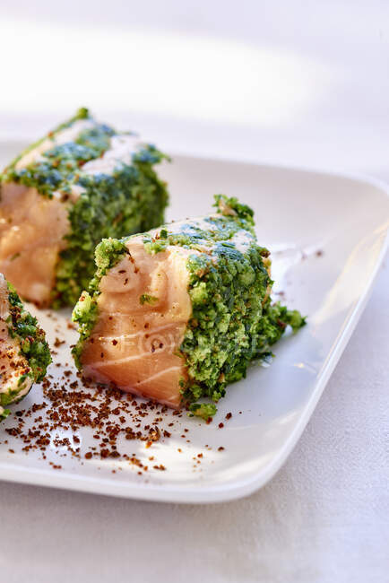Salmon in herbs coating with spices on plate — Stock Photo