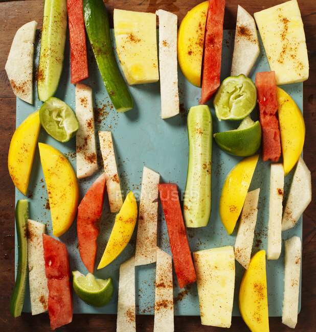 Jicama, vegetables and fruit cut into strips with lines and spices — Stock Photo
