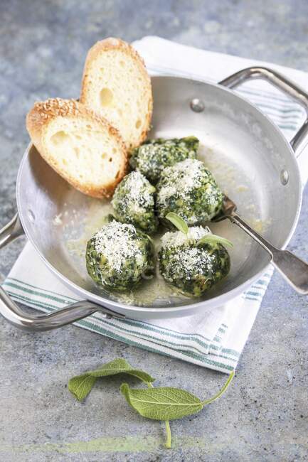 Homemade Canederli with spinach served with butter sage and parmesan cheese — Stock Photo