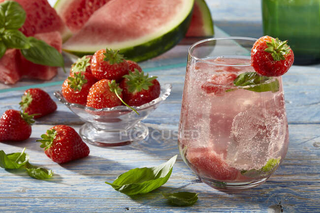 Lemonade with watermelon, strawberries and basil leaves — Stock Photo