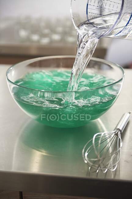 Ajouter de l'eau au mélange de gelée — Photo de stock