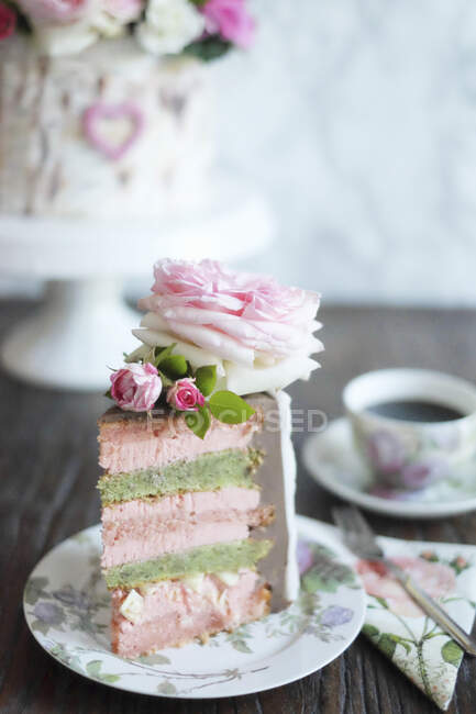 A slice of strawberry and pistachio cake decorated to look like a silver birch — Stock Photo
