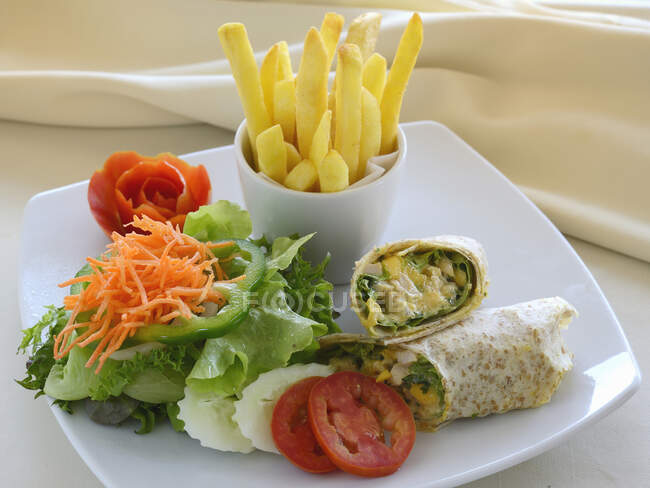 Wraps with a side salad and french fries — Stock Photo