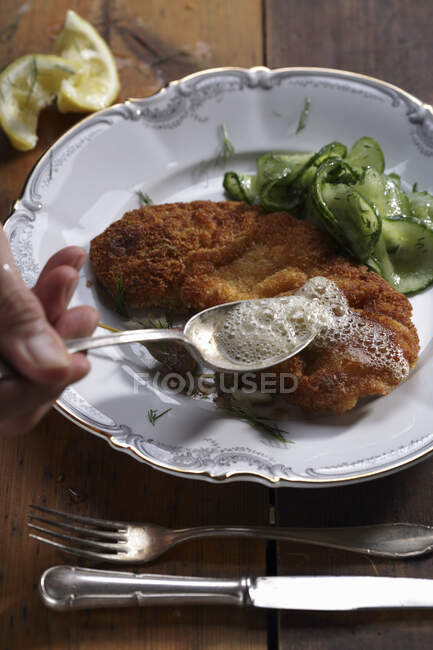Viennese schnitzel with a cucumber salad — Stock Photo